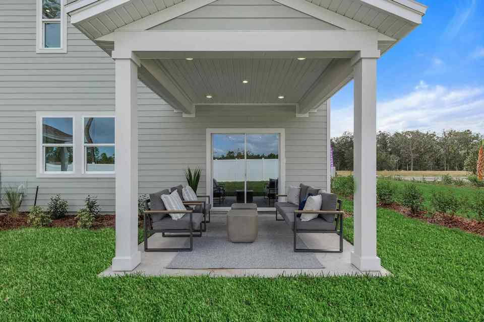 A house with a patio and a large glass door.