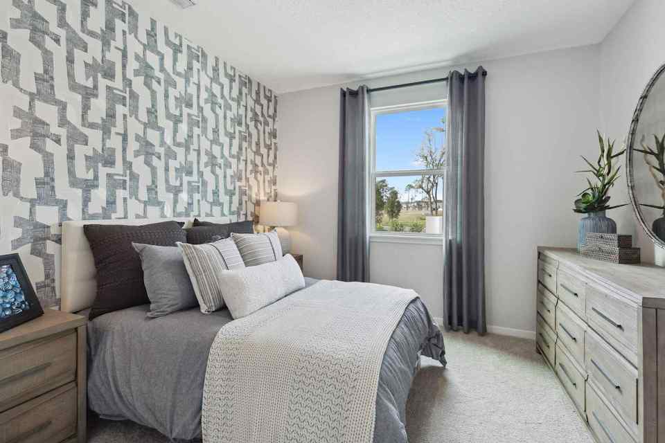 A bedroom with a bed and a window.