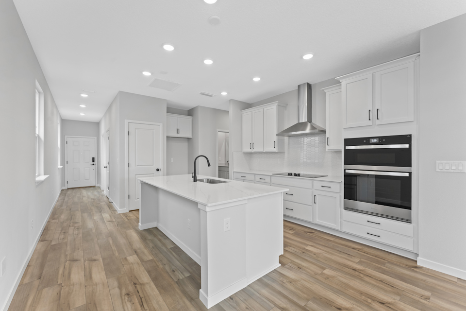 Miramar Floorplan Lot 81 Chef's Kitchen with White Cabinets at Concourse Crossing in Fernandina Beach