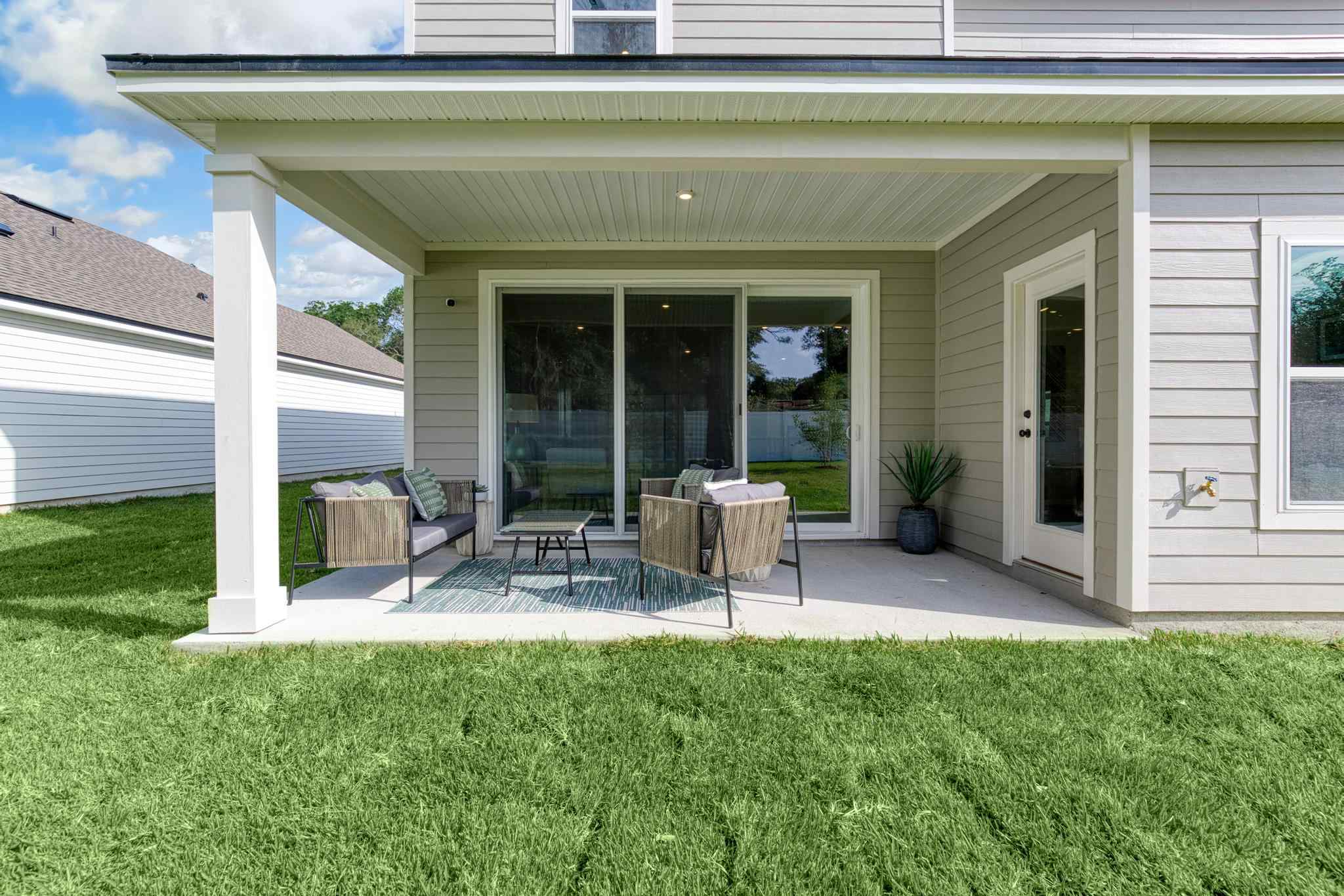 A house with a patio and a table and chairs.