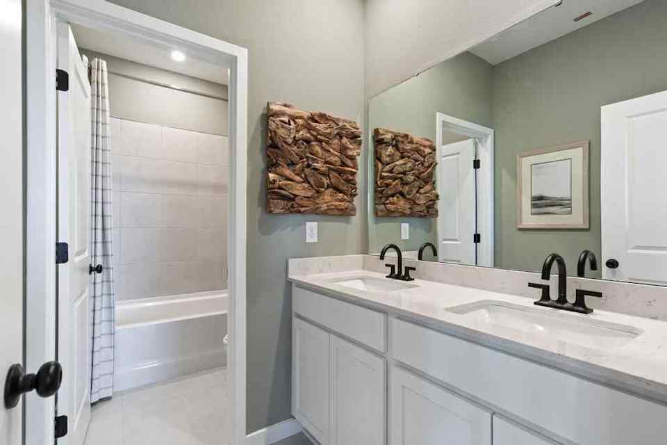 A bathroom with a sink and a shower.