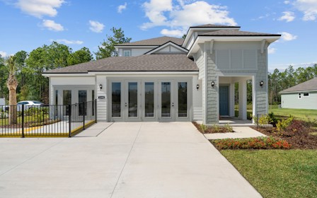 A white house with a driveway.