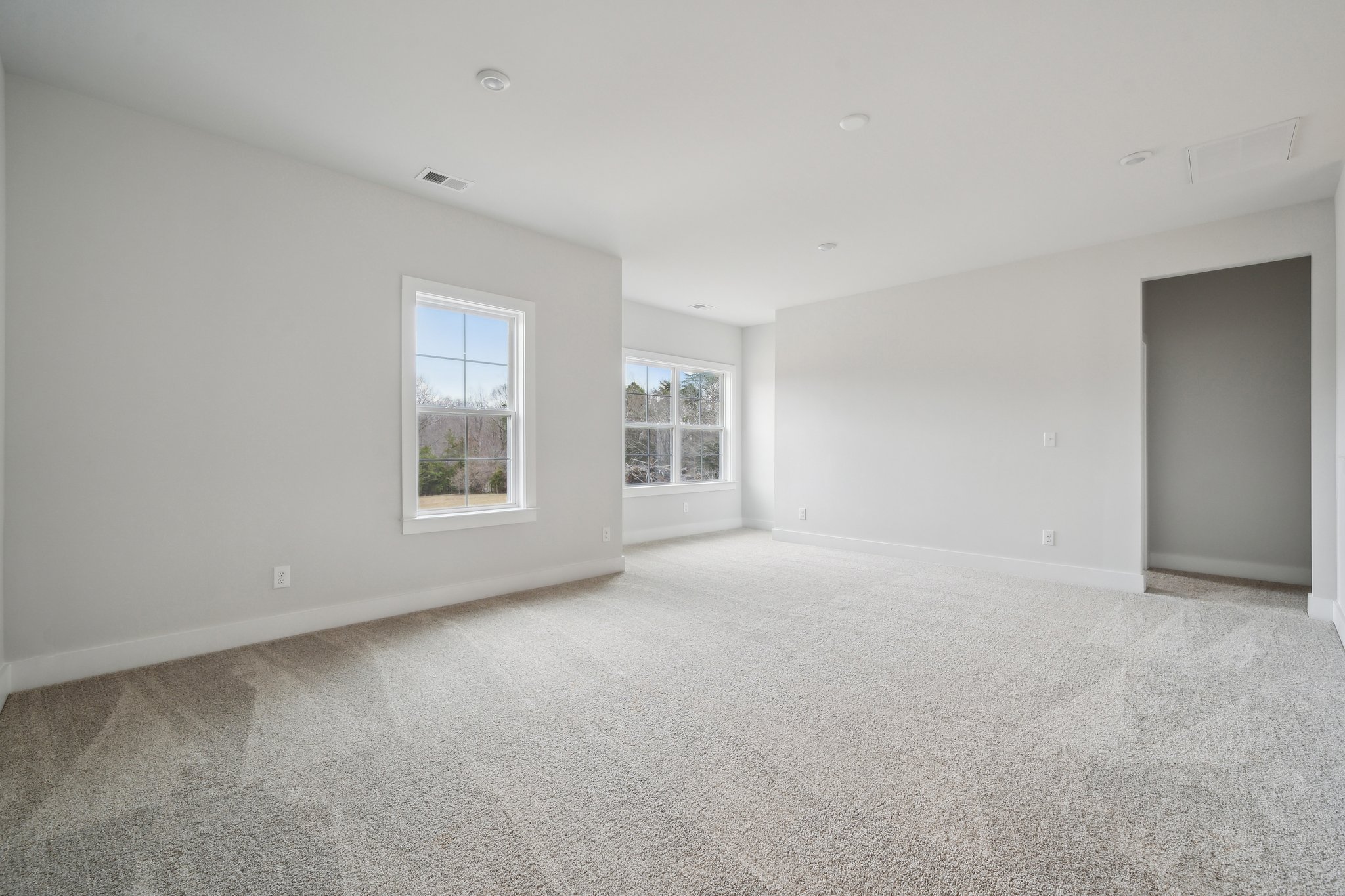 A room with a window and a carpet.