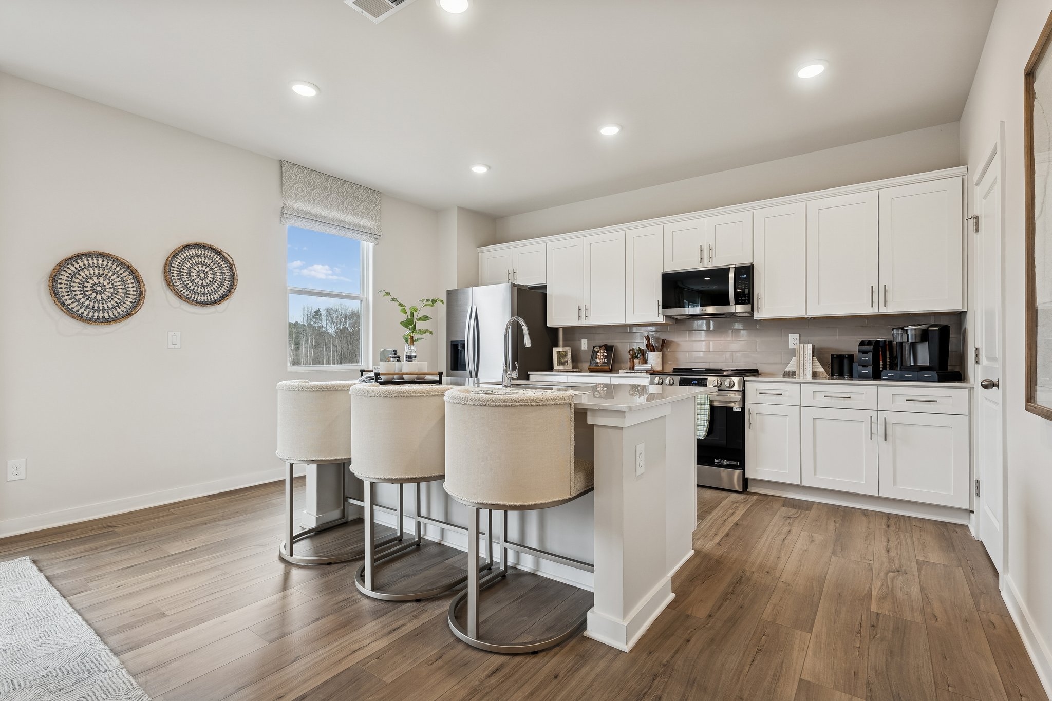A kitchen with white cabinets.