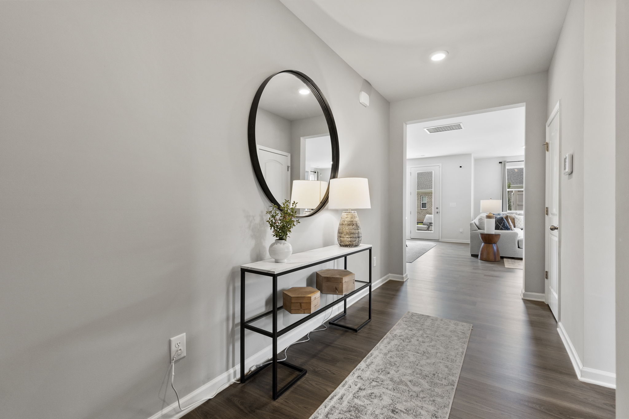 A room with a mirror and a table.