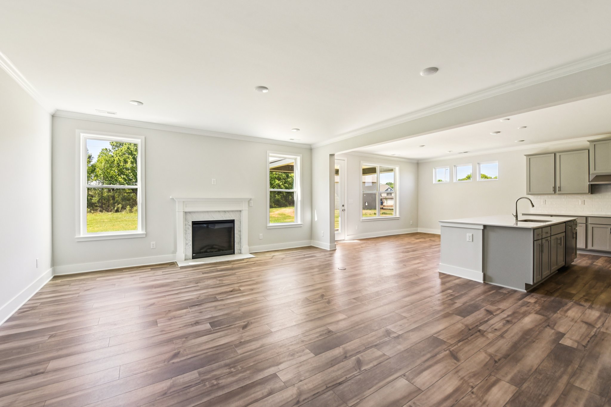 A large kitchen with a wood floor.