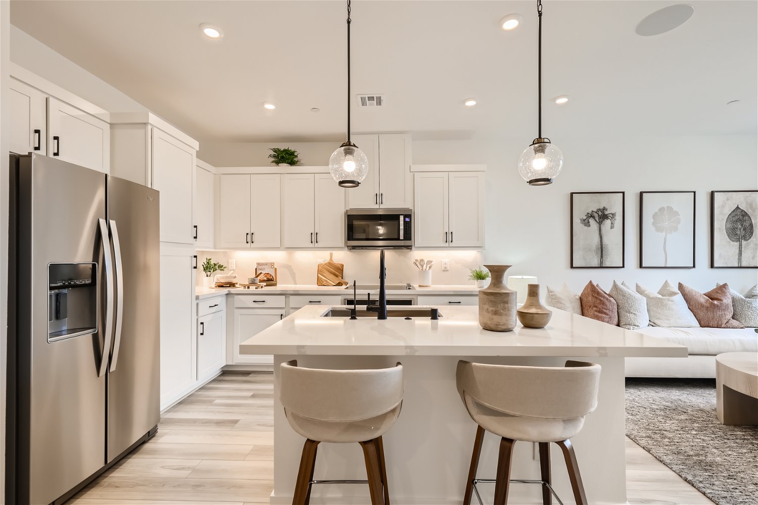 A kitchen with white cabinets.