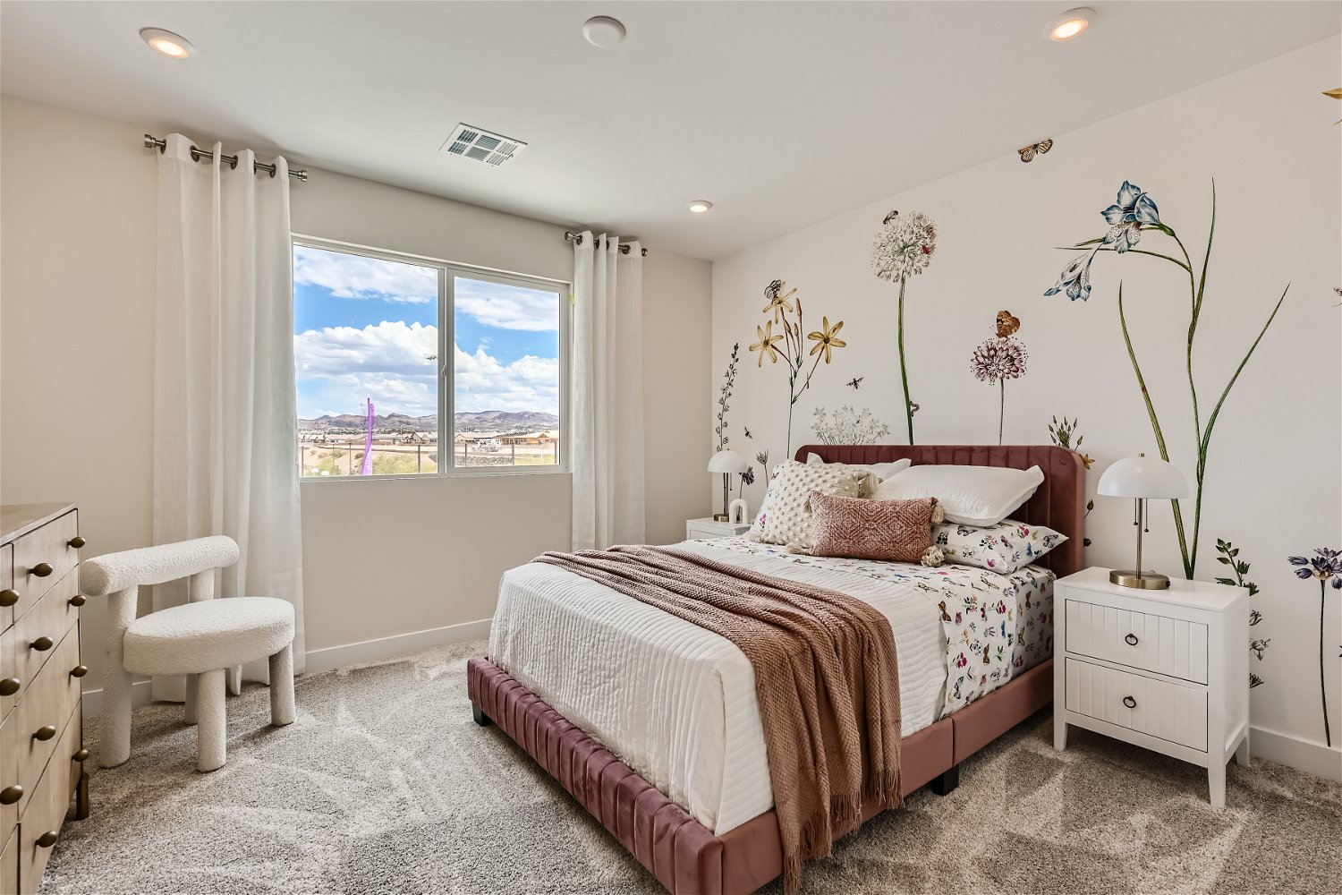 A bedroom with a large window.