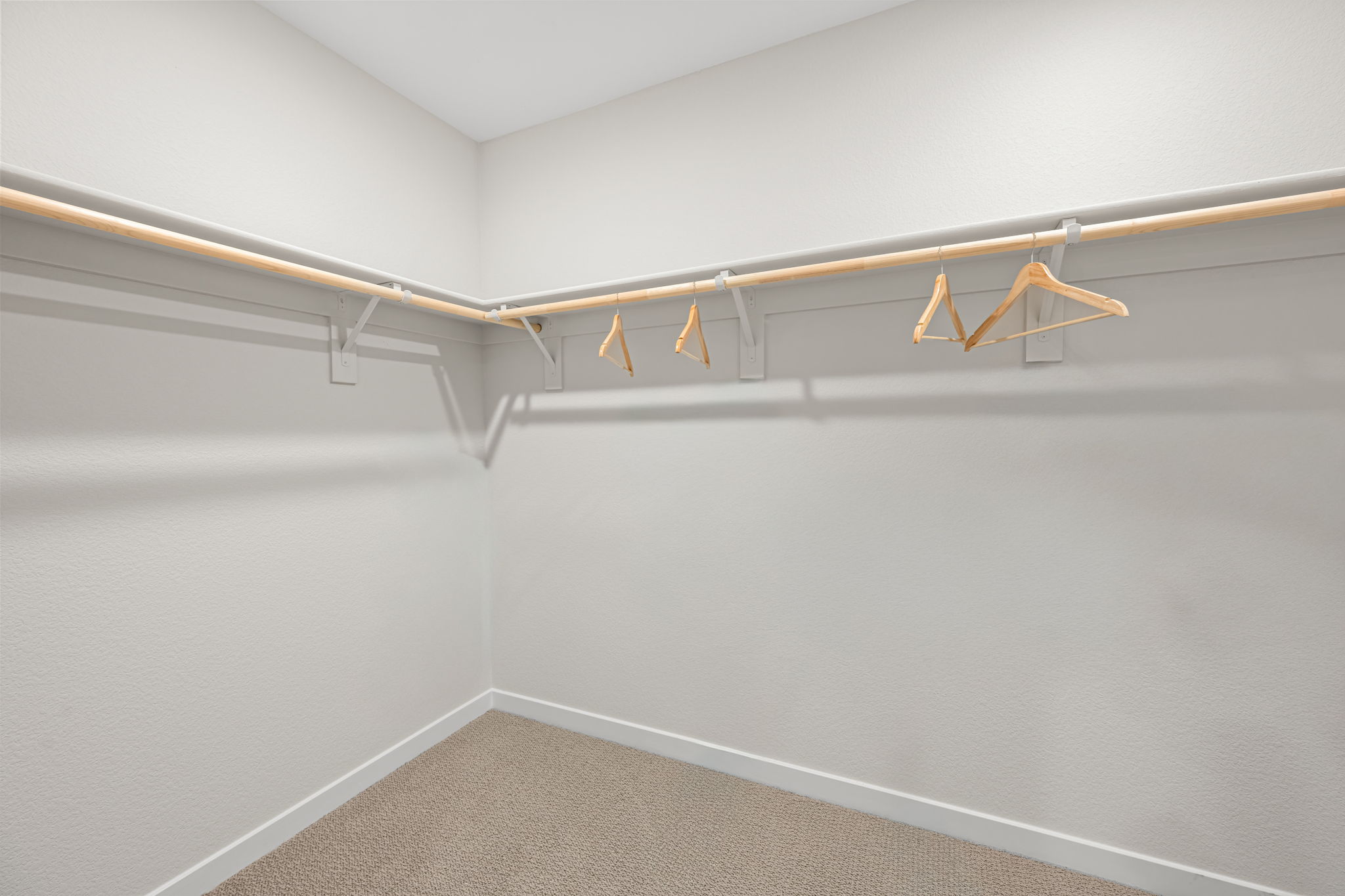 A white wall with a light fixture.