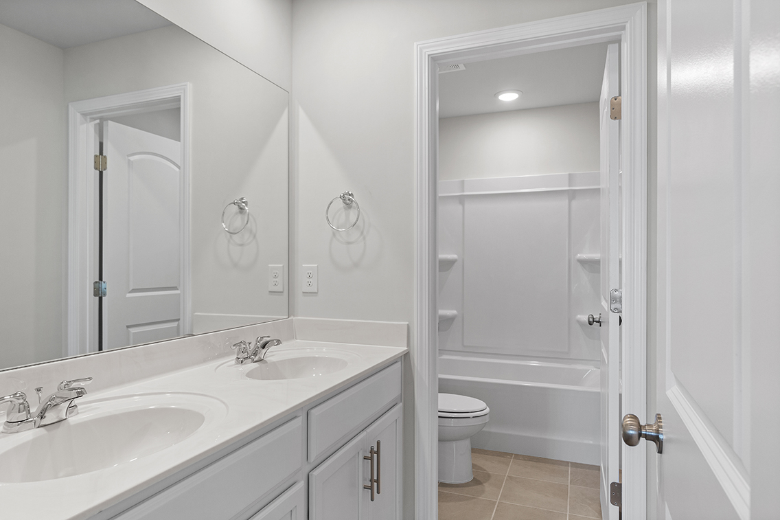A bathroom with a sink toilet and shower.