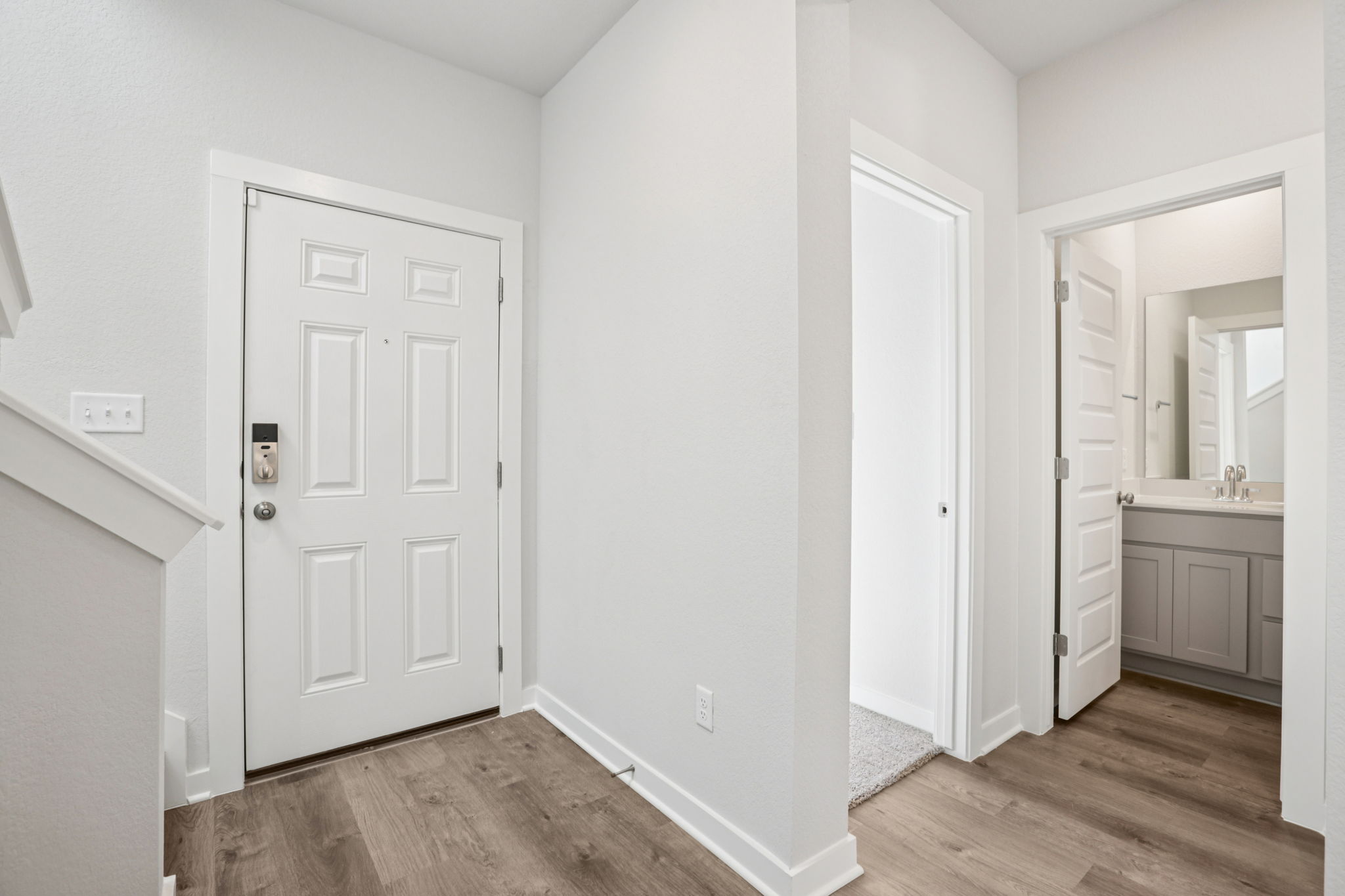 A bathroom with white doors.