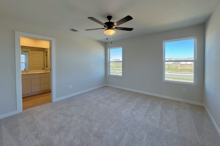 A room with a ceiling fan and a window.