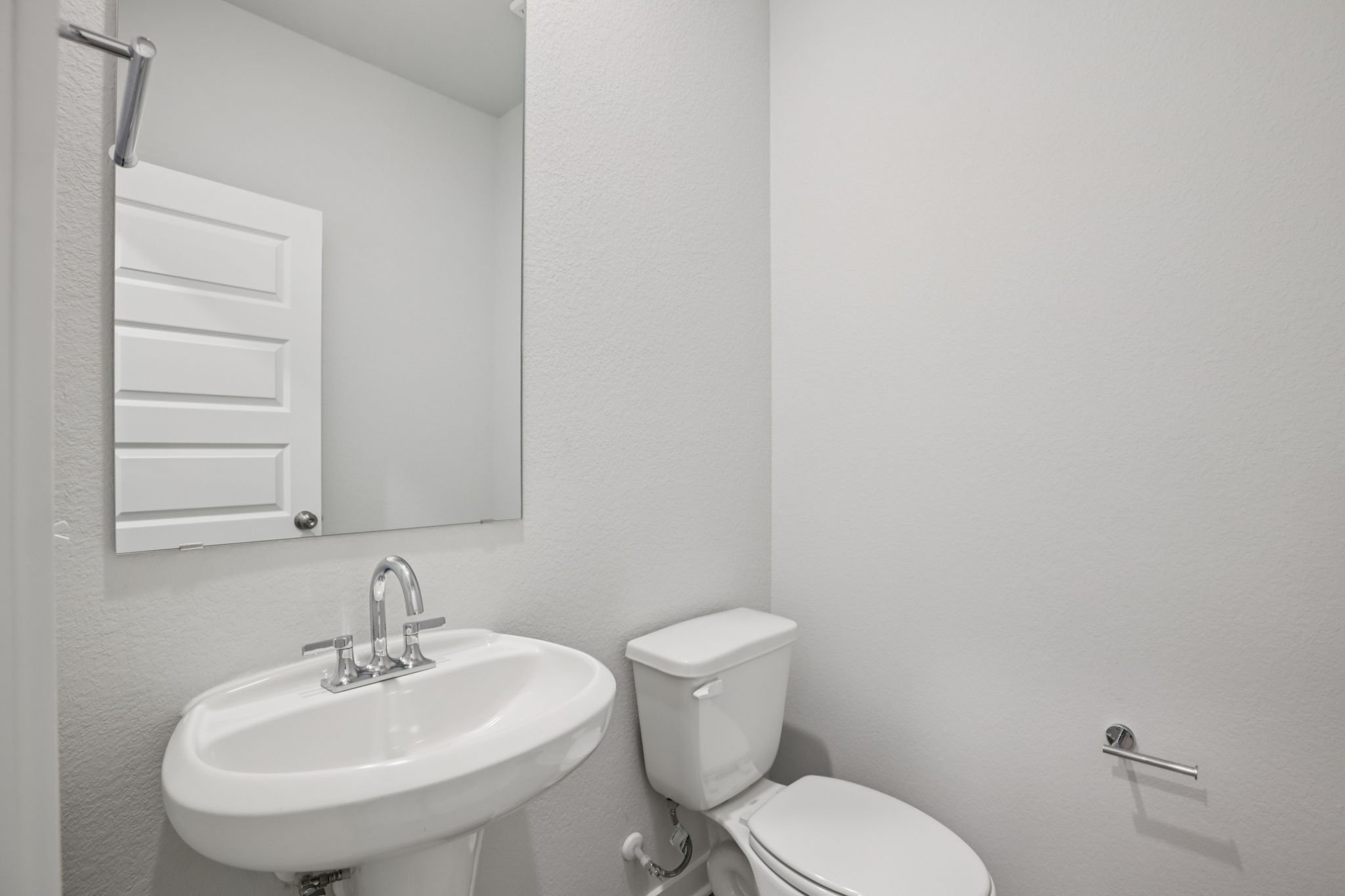 A bathroom with a sink and toilet.