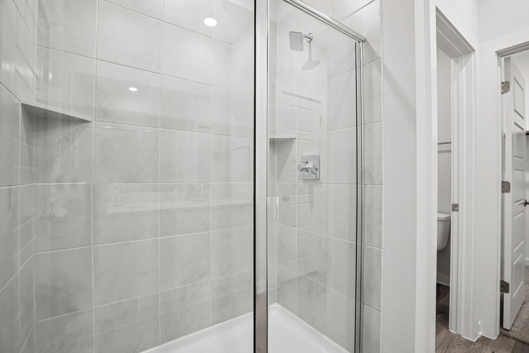 A shower with a glass door.