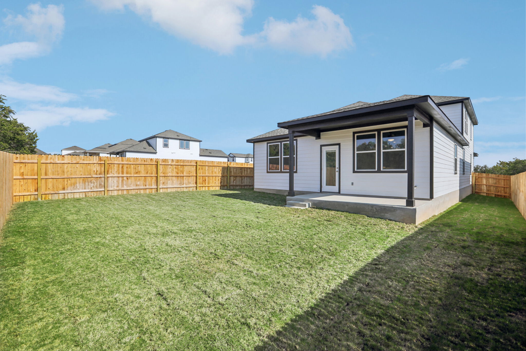 A small house in a grassy yard.
