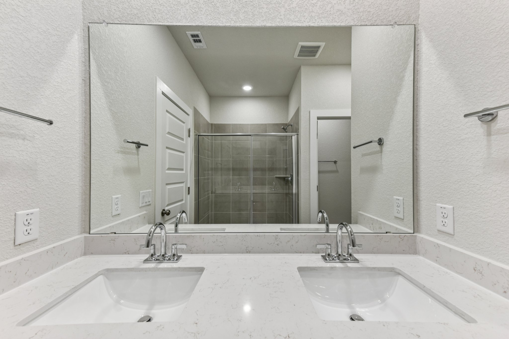 A bathroom with a large mirror.