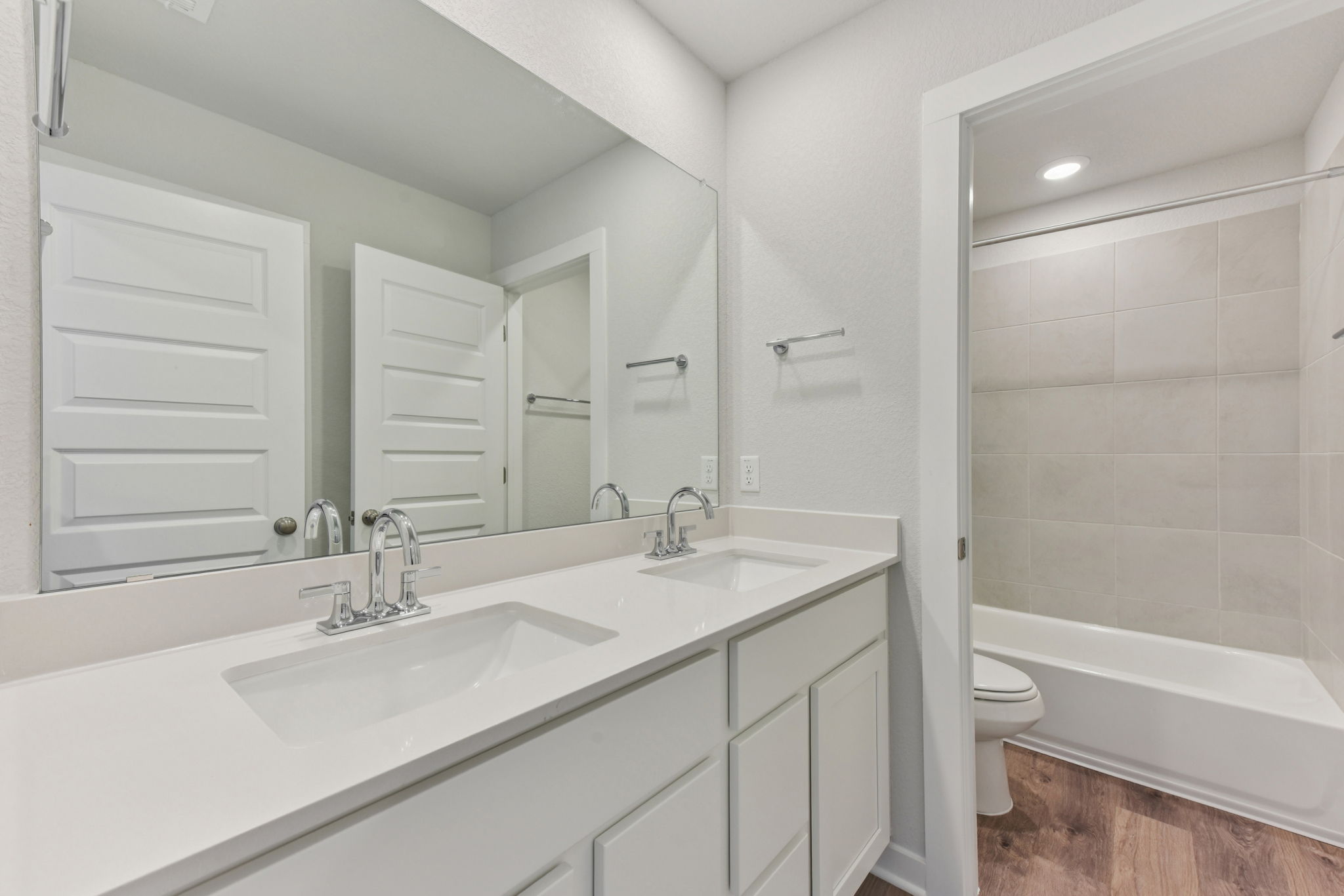 A bathroom with a sink toilet and bathtub.