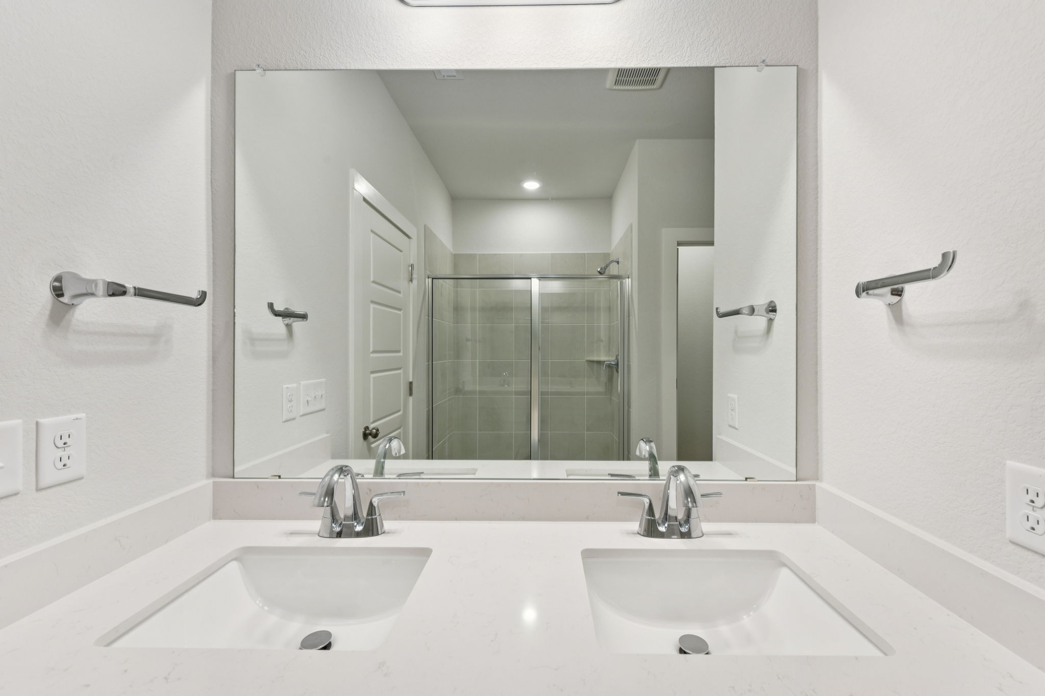 A bathroom with a large mirror.