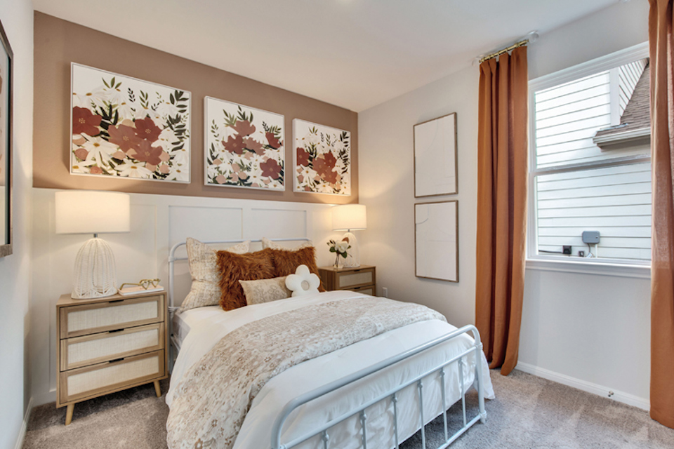 A bedroom with a bed and lamps.