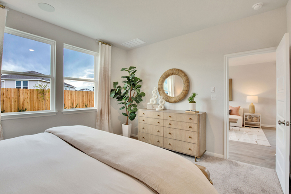 A bedroom with a large window.