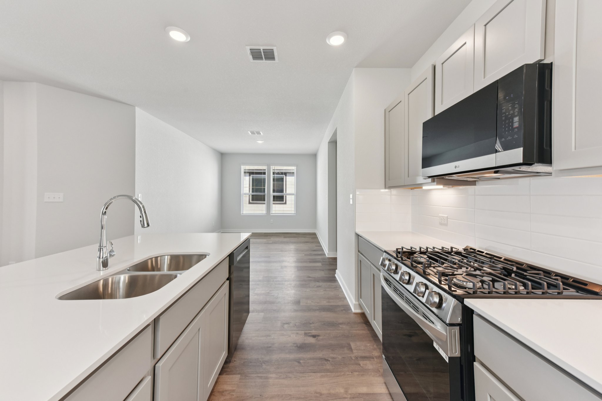 A kitchen with white cabinets.