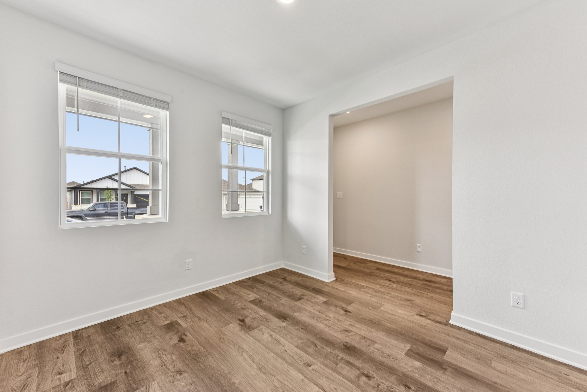 A room with a wood floor and a window.
