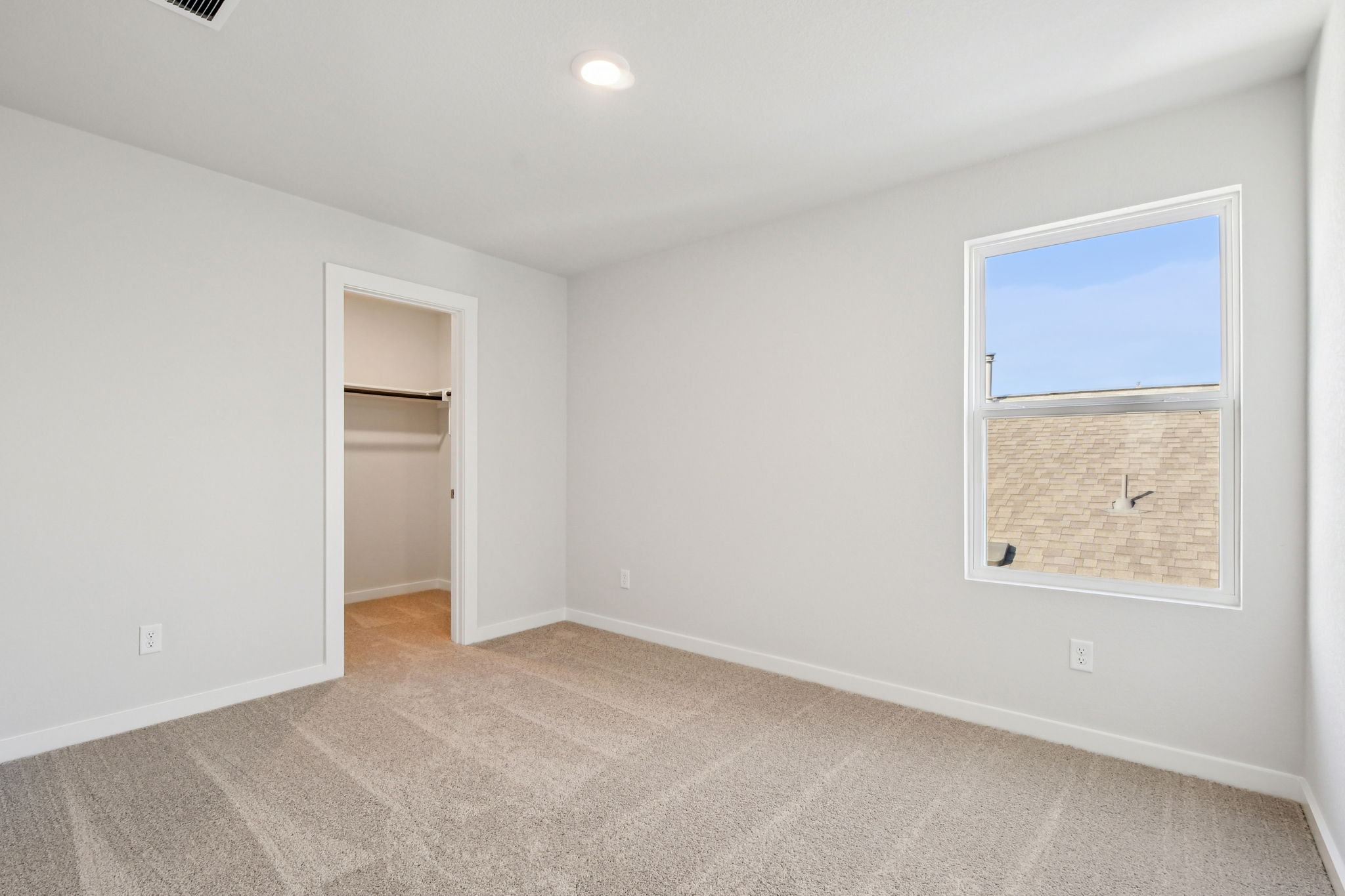 A room with a window and a door.