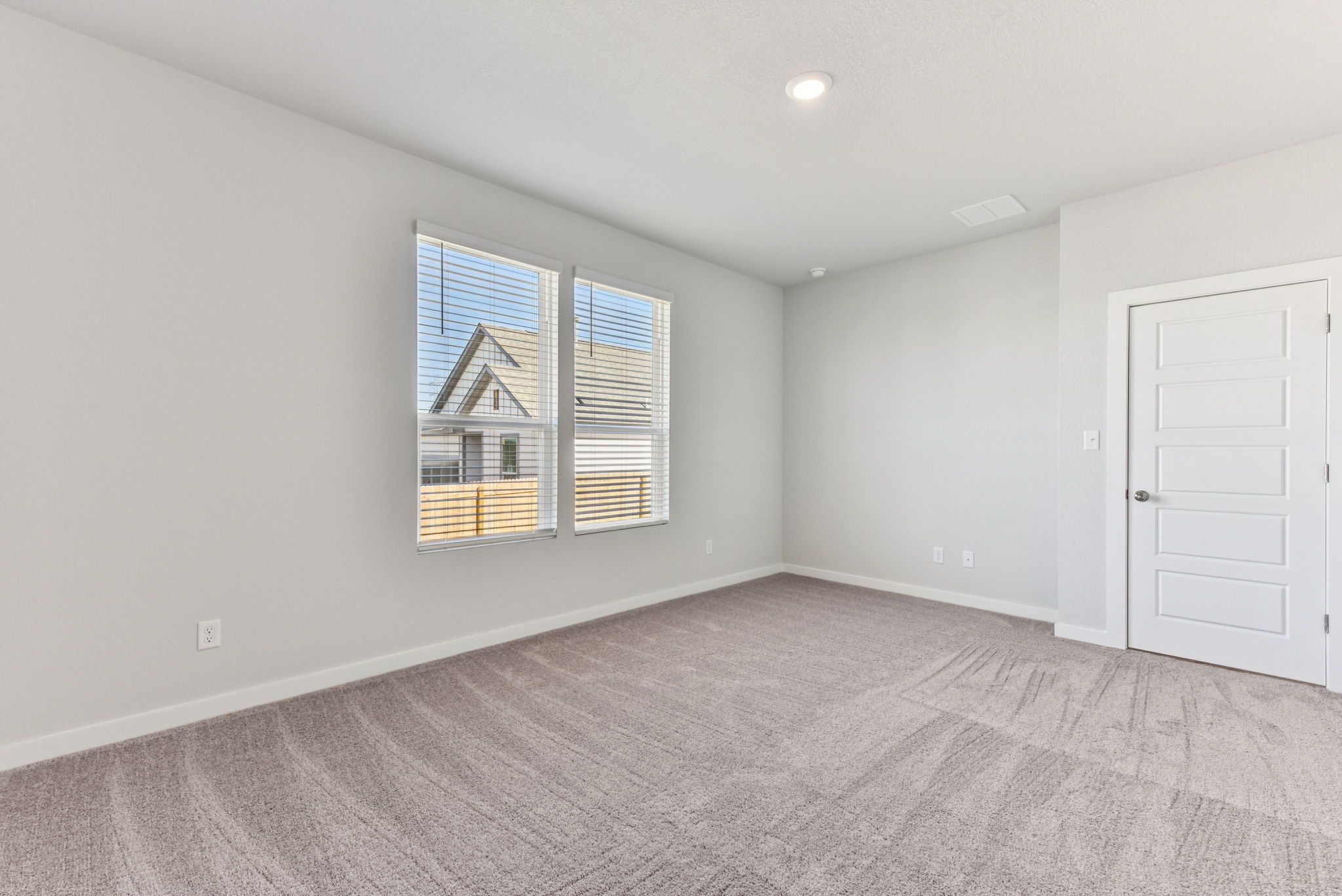 A room with a window and a door.