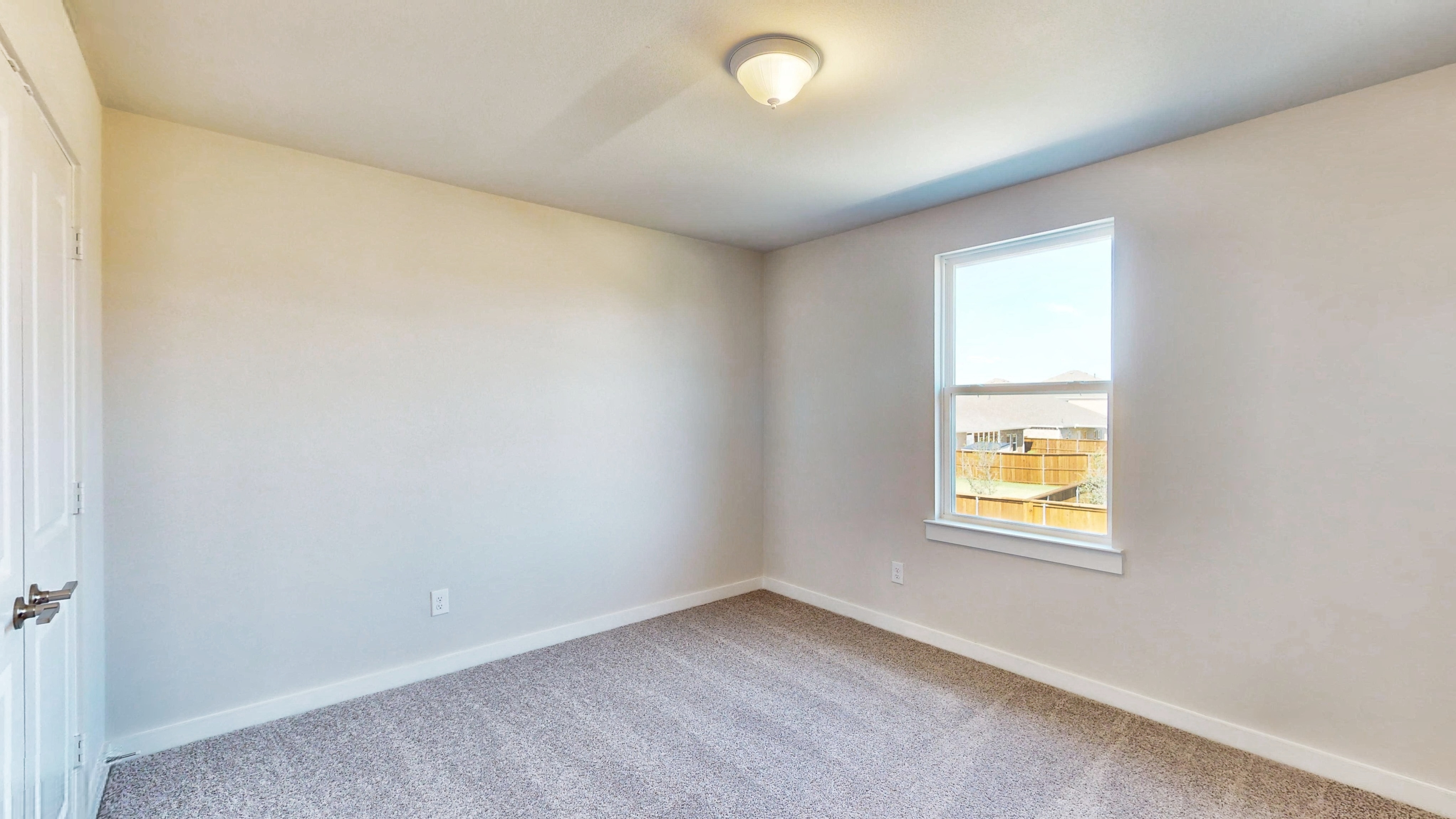 A room with a window and a carpet.