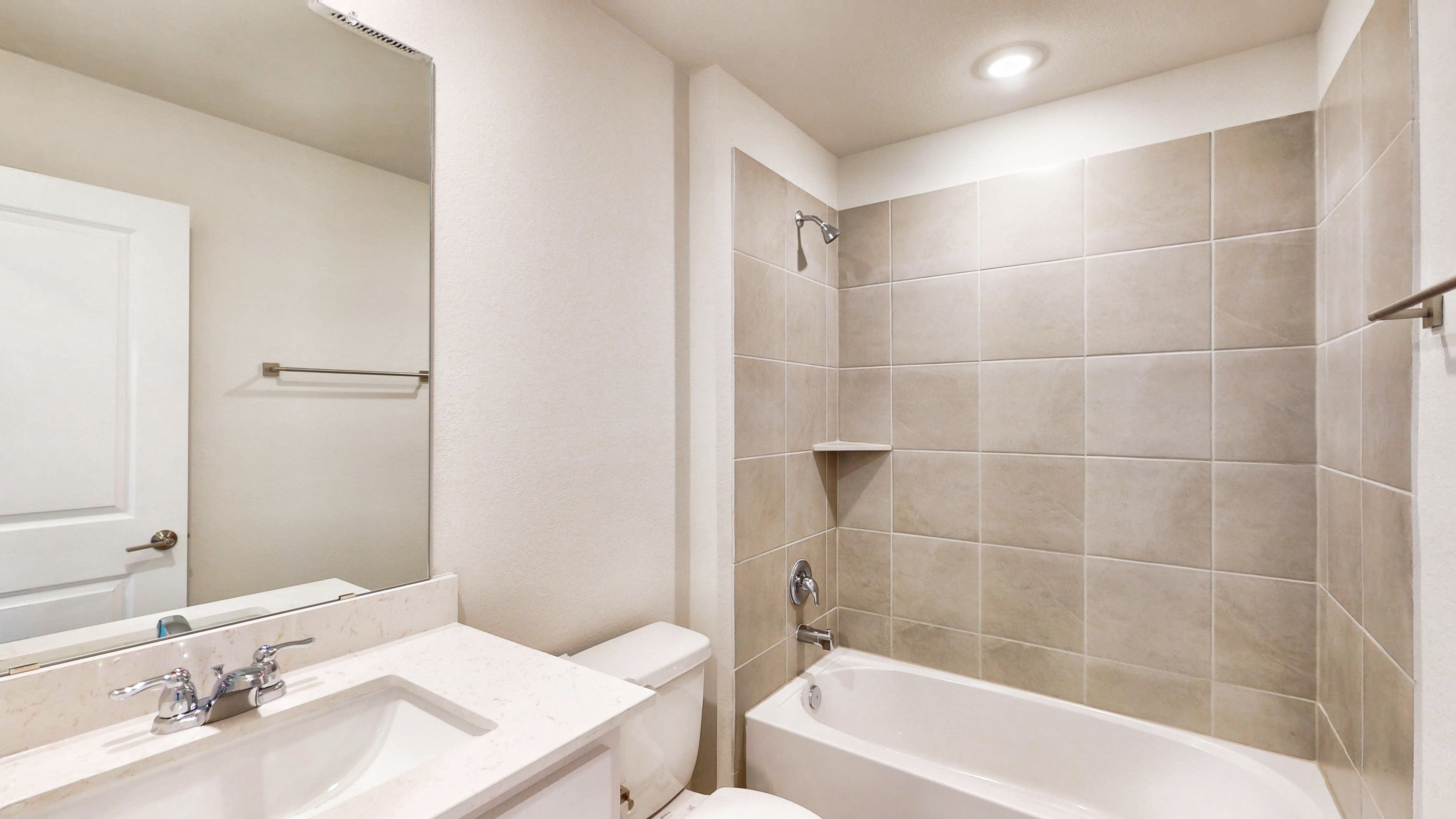 A bathroom with a tub sink and toilet.