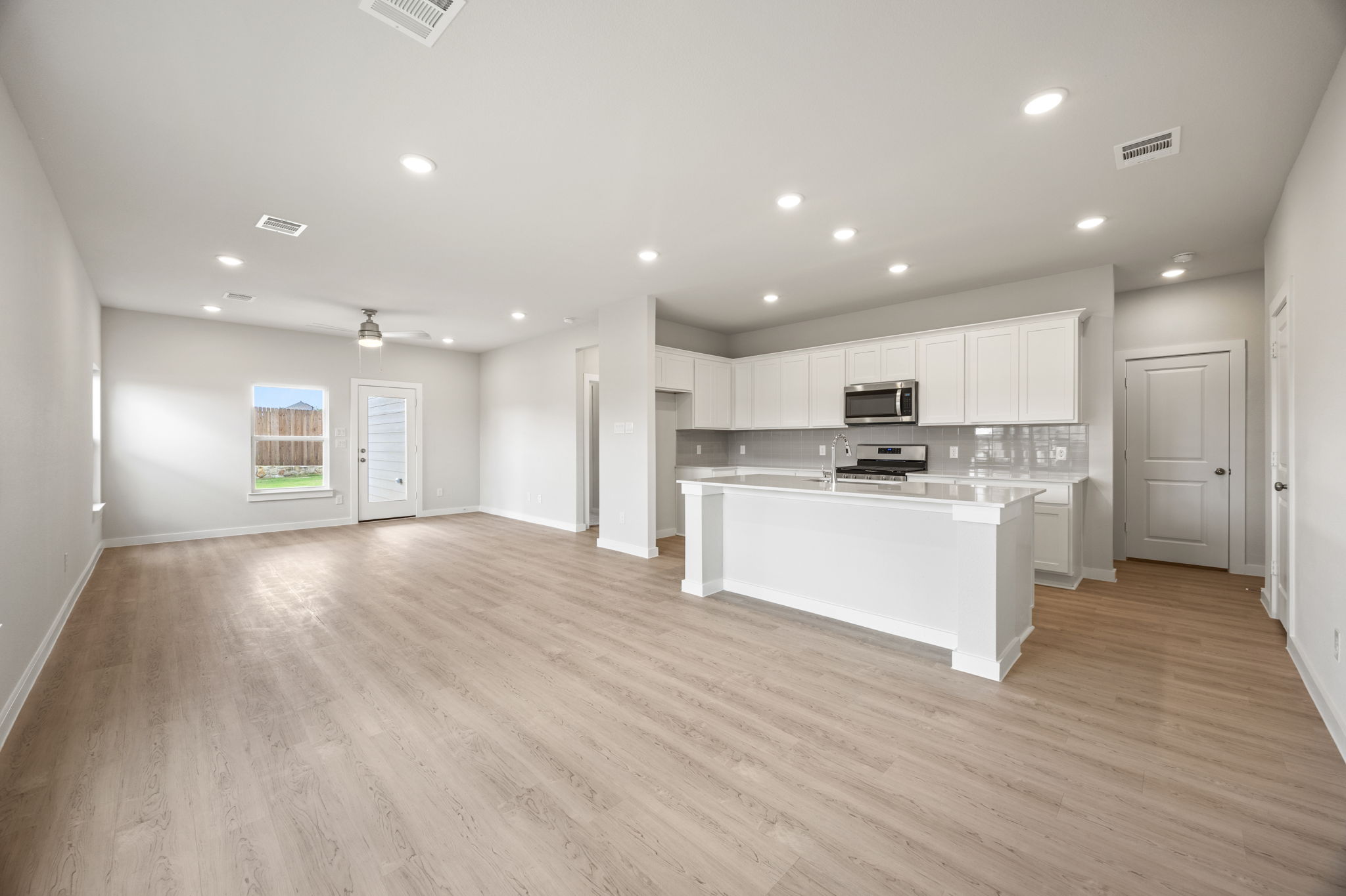 A large kitchen with white cabinets.