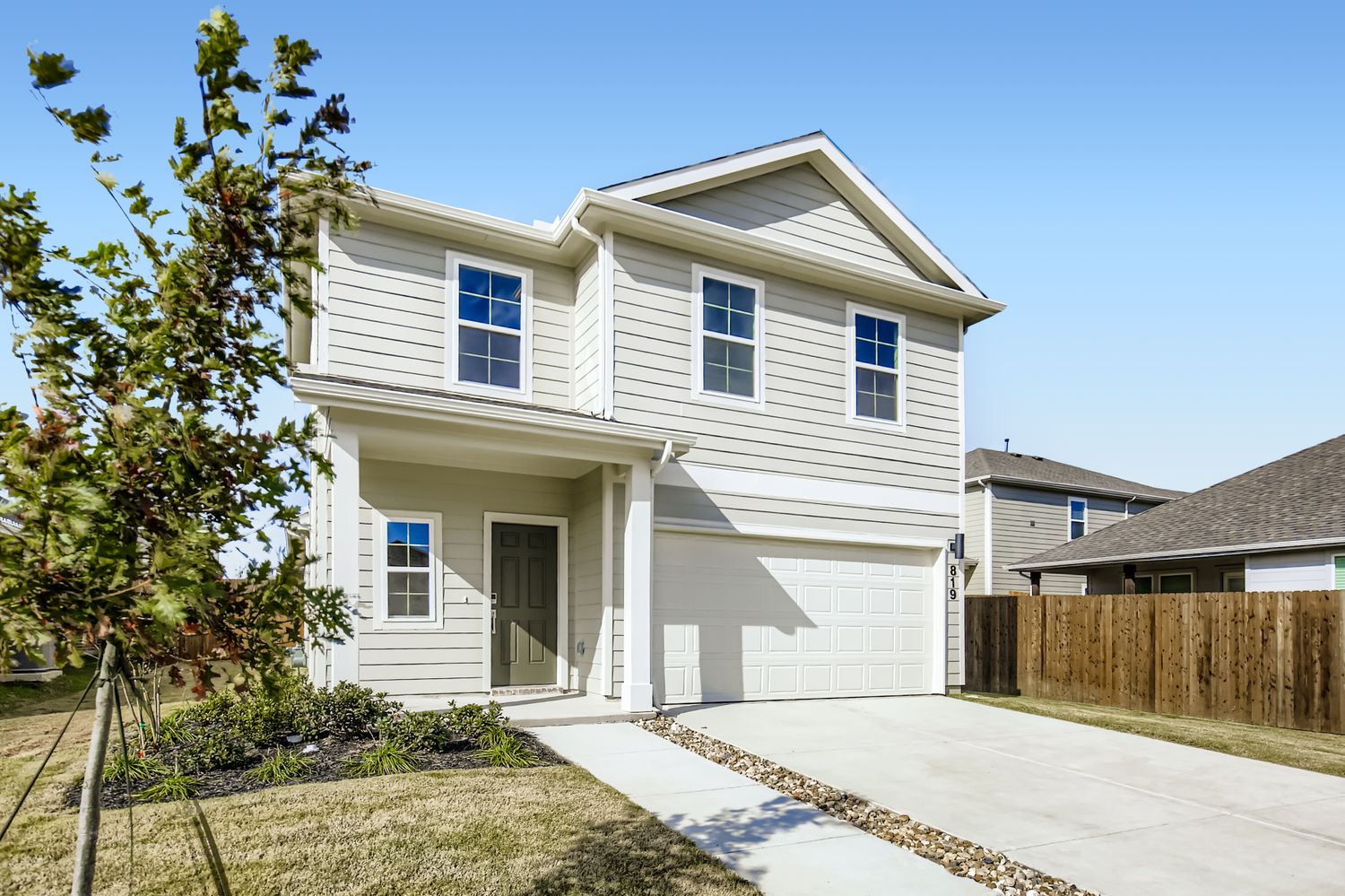 A white house with a driveway.