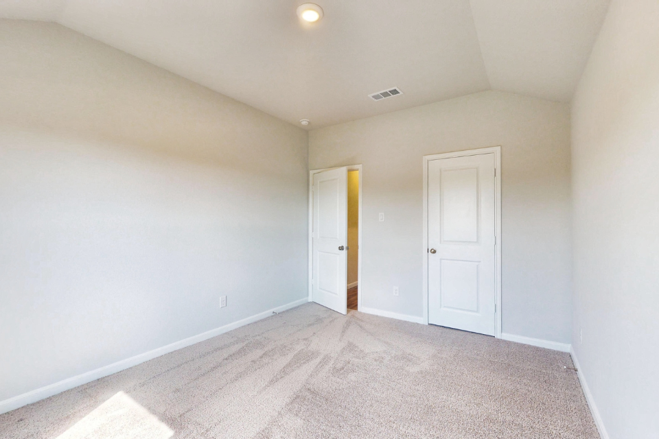 A hallway with white doors.