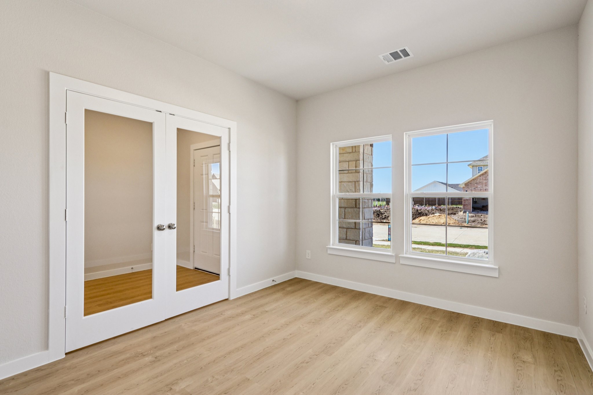 A room with a window and a door.