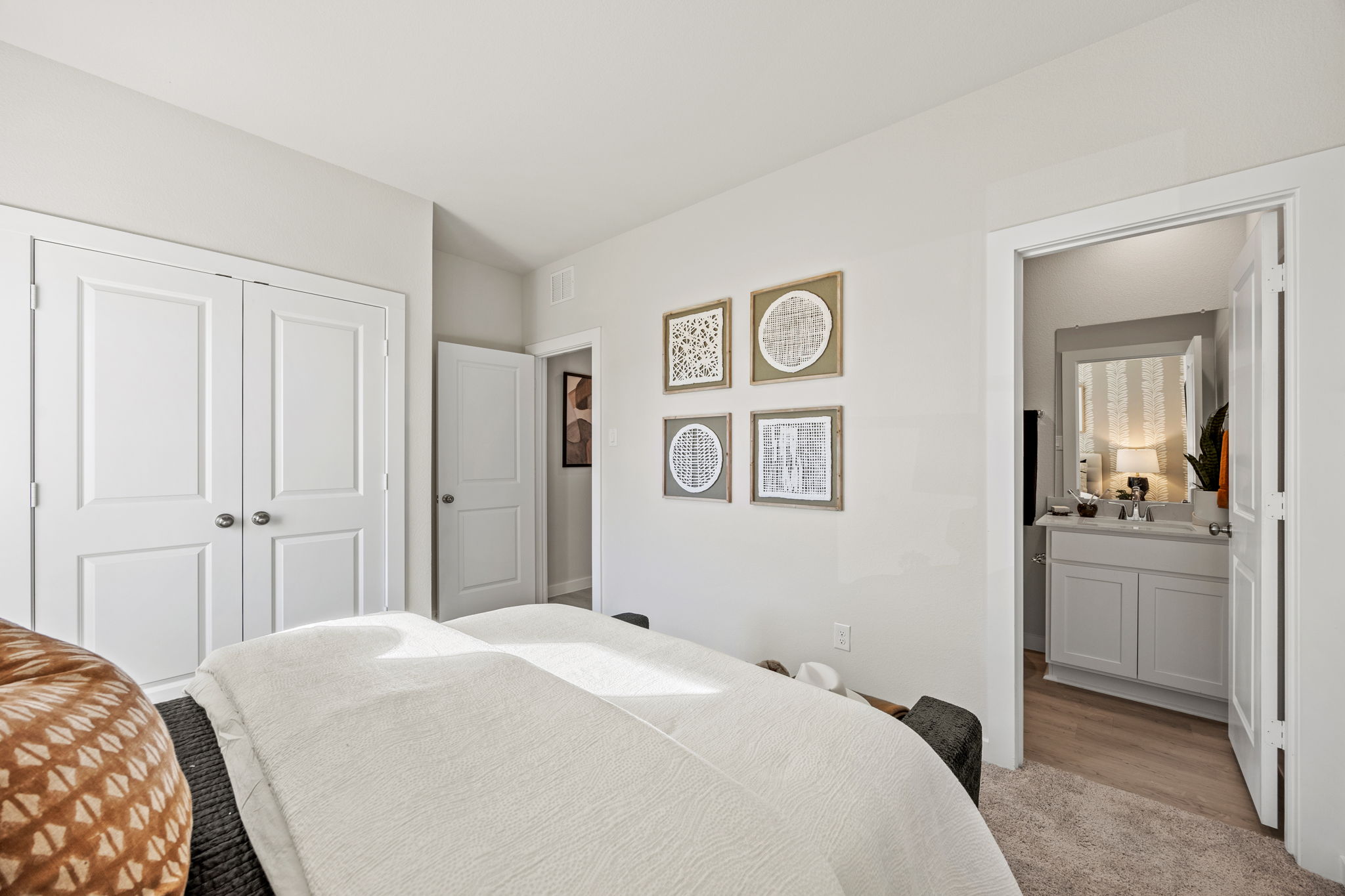 A bedroom with a bed and a mirror.