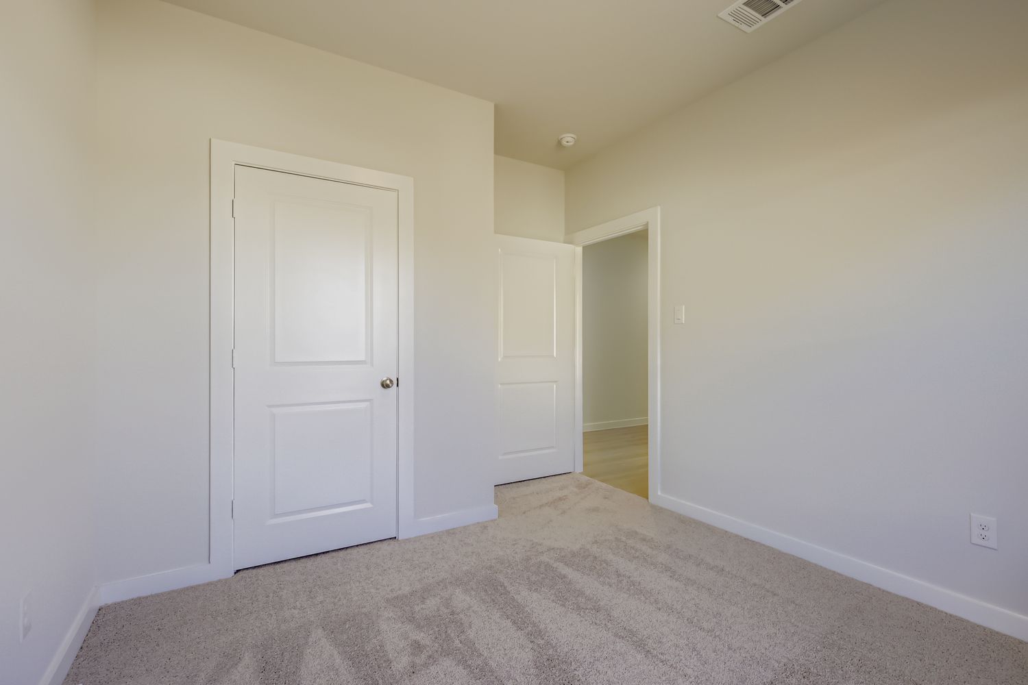 A hallway with white doors.