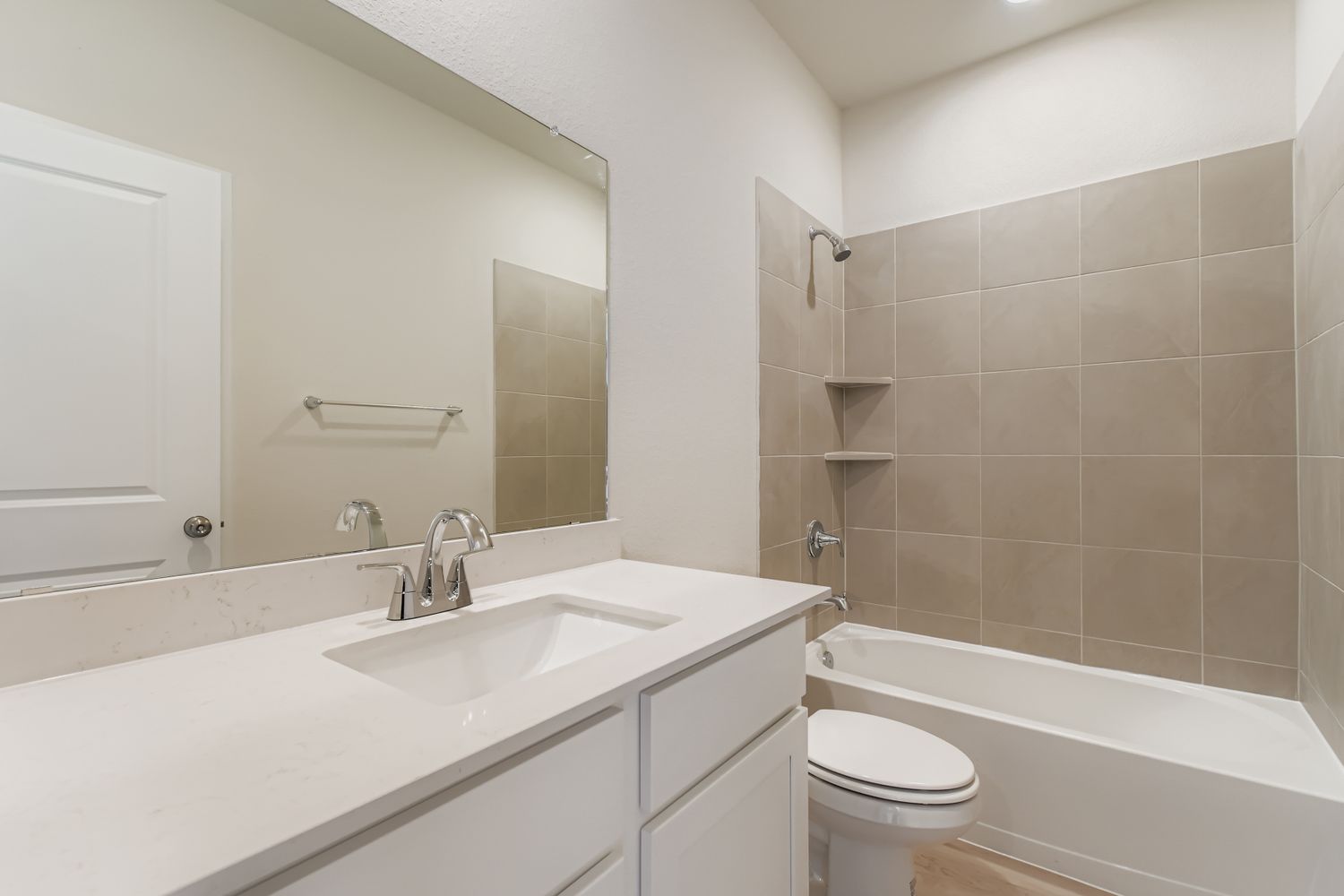 A bathroom with a sink toilet and bathtub.