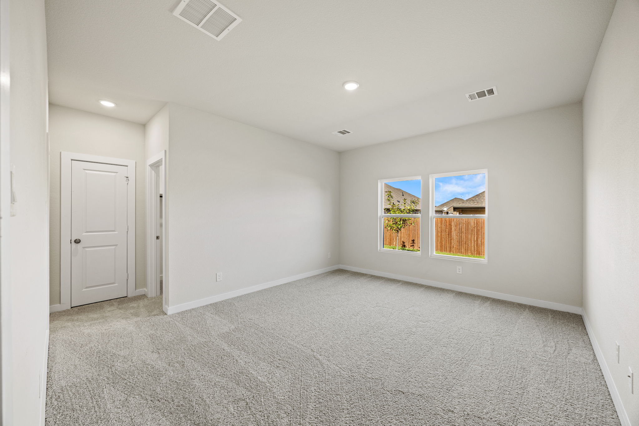 A room with a carpet and a rug.
