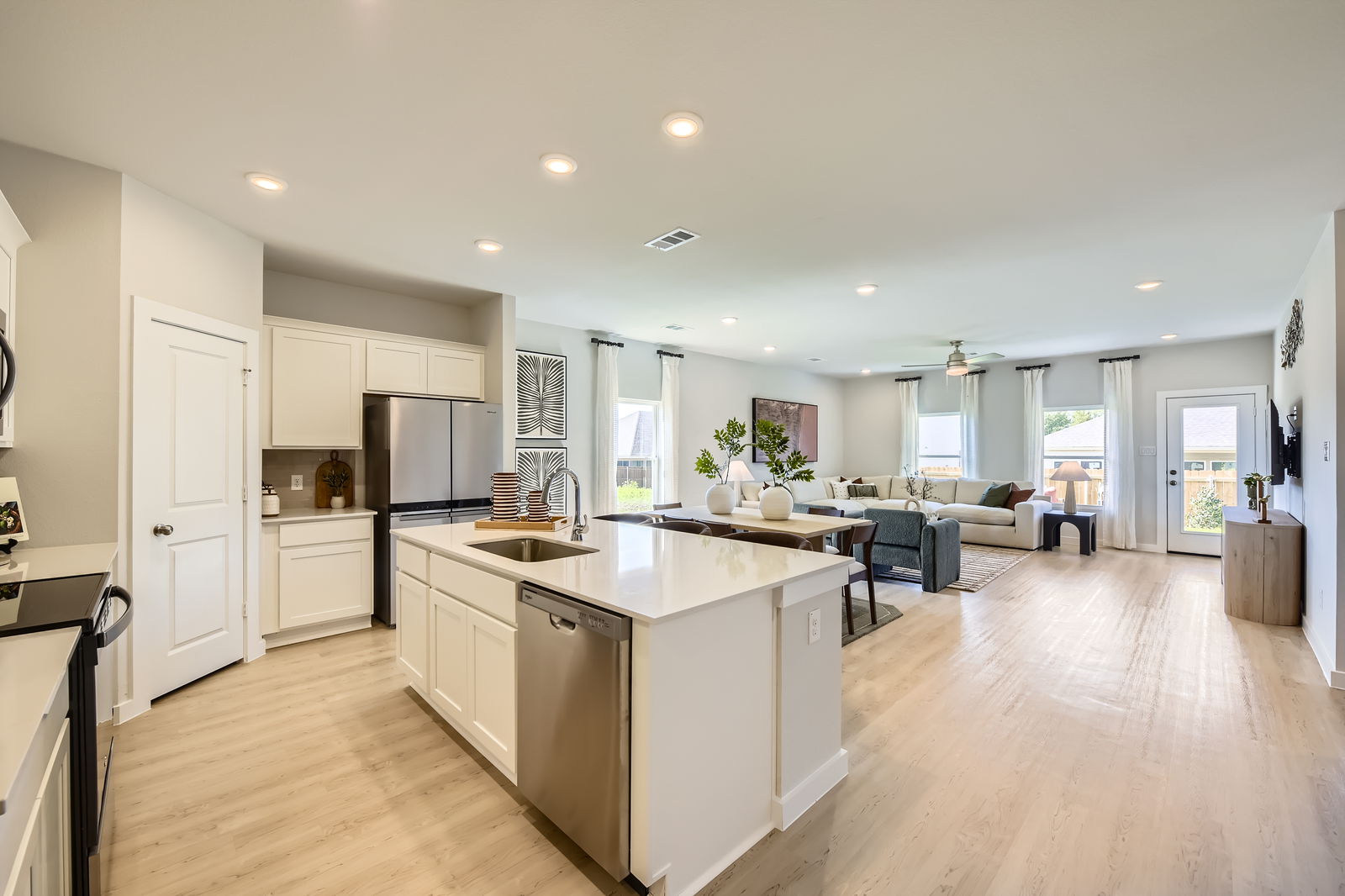 A kitchen with white cabinets.