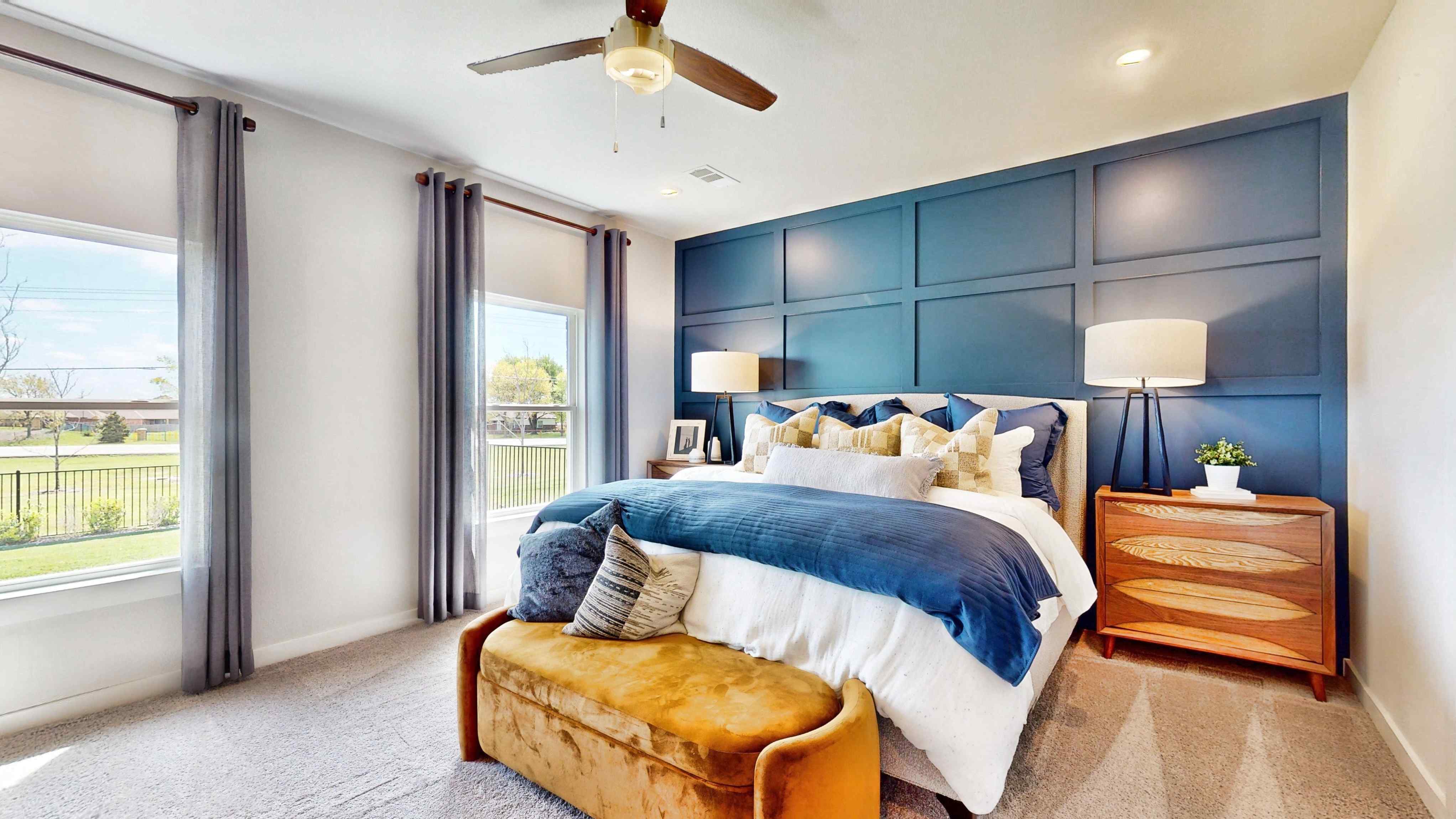 A bedroom with a large bed and a large window.