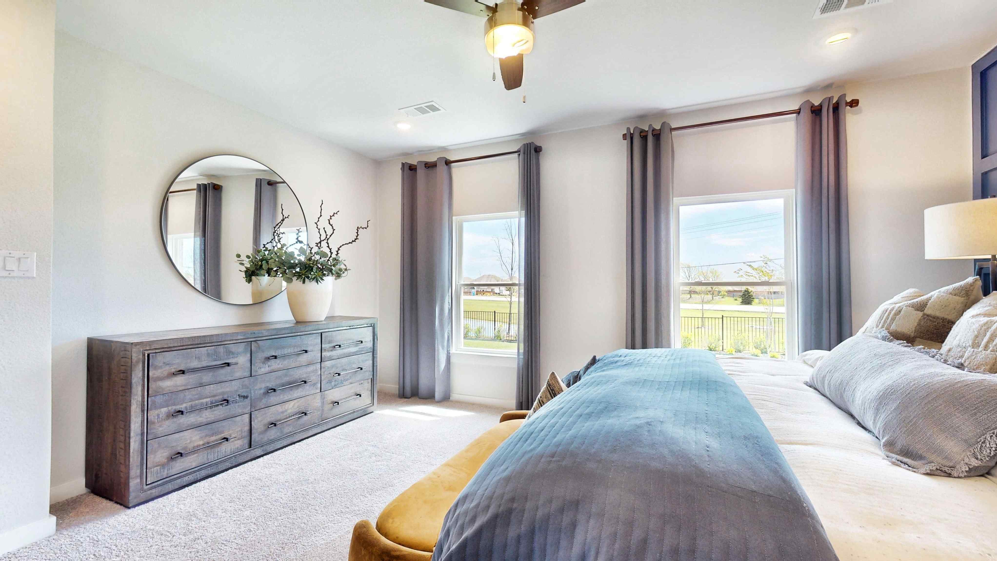 A bedroom with a large window.