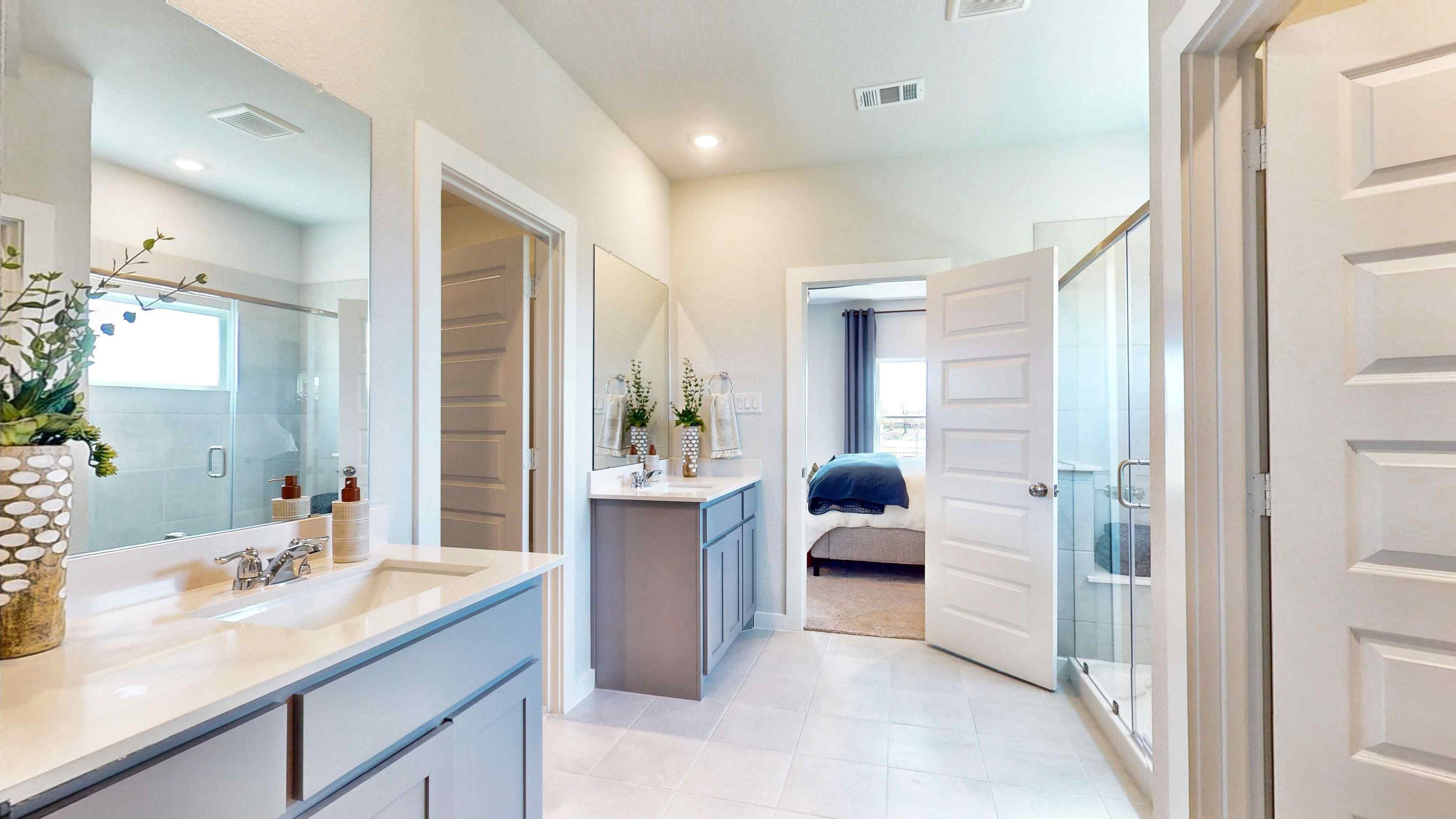 A bathroom with a sink and a bed.