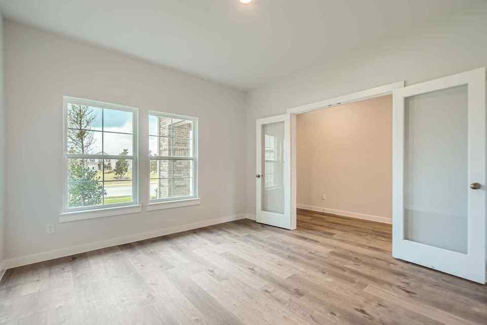 A room with a wood floor and a window.