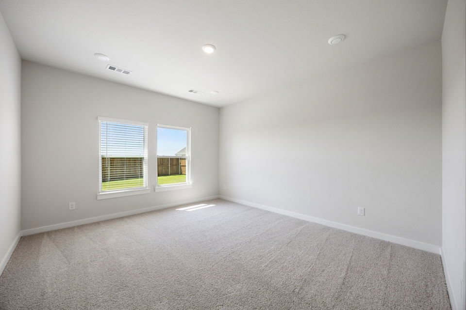 A room with a window and a carpet.
