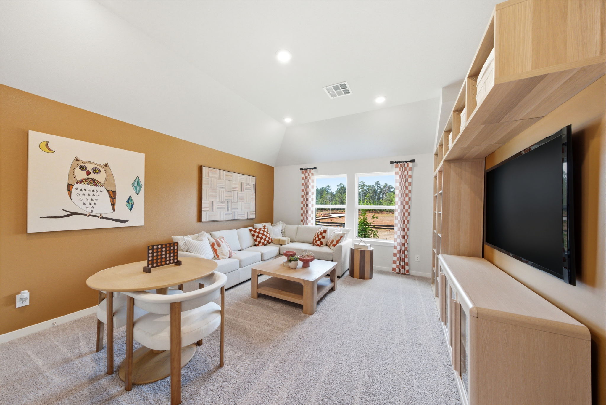 A living room with a tv and couches.