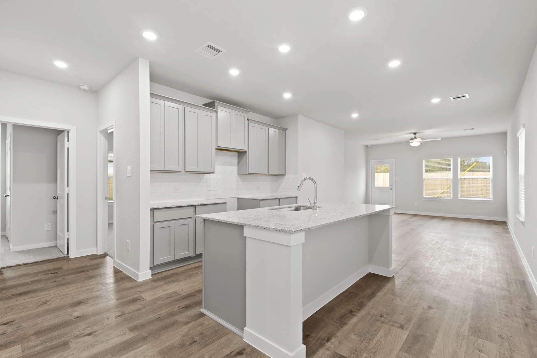 A kitchen with white cabinets.