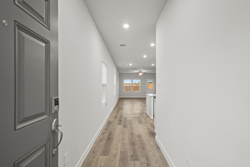 A hallway with white walls.