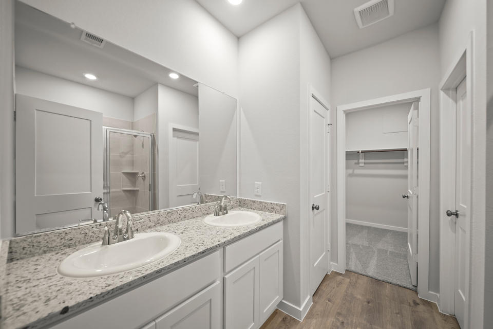 A bathroom with a large mirror.