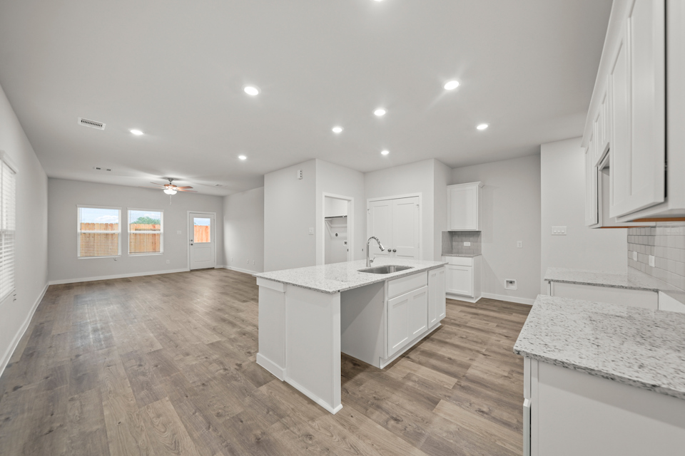 A kitchen with white cabinets.