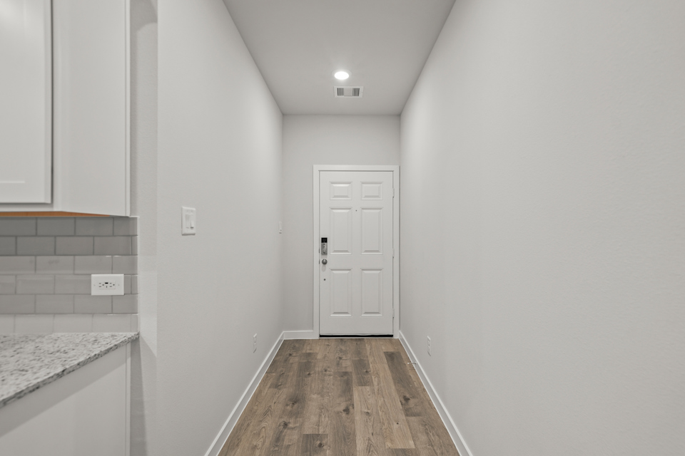 A hallway with white walls.